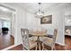 Charming dining area features built-in bench seating, round table, stylish light fixture, and wood floors at 470 Lakeview Shores Loop, Mooresville, NC 28117