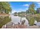 Inviting dock view with chairs and small table overlooking the serene lake and boat docks, perfect for lakeside relaxation at 470 Lakeview Shores Loop, Mooresville, NC 28117