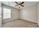 Bright bedroom with ceiling fan and neutral carpeting at 14426 Asheton Creek Dr, Charlotte, NC 28273