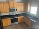 Kitchen with wood cabinets, granite countertops, and sink at 14426 Asheton Creek Dr, Charlotte, NC 28273