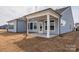 Back porch with neutral siding and large beams for support at 3228 Gavin Ln, Harrisburg, NC 28075
