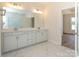 Bright bathroom featuring a double vanity with modern finishes and a view into the shower at 3228 Gavin Ln, Harrisburg, NC 28075