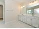 Bathroom features a double vanity with a quartz countertop and white cabinets at 3228 Gavin Ln, Harrisburg, NC 28075