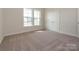 This bedroom has carpet and two double-hung windows for lots of natural light at 3228 Gavin Ln, Harrisburg, NC 28075
