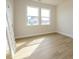 Cozy bedroom showcasing a large window and new laminate wood flooring at 3228 Gavin Ln, Harrisburg, NC 28075