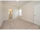 Neutral bedroom with carpet flooring, a window, and a view into the ensuite bathroom at 3228 Gavin Ln, Harrisburg, NC 28075