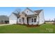 Attractive one-story home featuring stone accents, a two-car garage, and a well-maintained lawn at 3228 Gavin Ln, Harrisburg, NC 28075