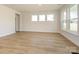 Spacious, naturally-lit living area with beautiful hardwood floors and trim at 3228 Gavin Ln, Harrisburg, NC 28075