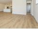 Open-concept living area with hardwood floors that flows into the modern kitchen at 3228 Gavin Ln, Harrisburg, NC 28075