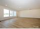 Expansive living room featuring natural light, hardwood floors, and recessed lighting at 3228 Gavin Ln, Harrisburg, NC 28075