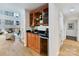 Stylish bar area with wood cabinets, black countertop, and wine cooler at 435 S Tryon St # 301, Charlotte, NC 28202