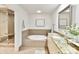 Luxurious bathroom with a soaking tub, glass-enclosed shower, and granite countertops at 435 S Tryon St # 301, Charlotte, NC 28202