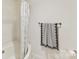 Clean bathroom with a shower and a stylish patterned shower curtain at 435 S Tryon St # 301, Charlotte, NC 28202