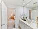 Modern bathroom with a large mirror, white cabinets, and a view into the adjacent bedroom at 435 S Tryon St # 301, Charlotte, NC 28202