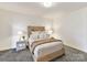 Well-lit bedroom features a queen bed, side tables with lamps, and a cozy animal print carpet at 435 S Tryon St # 301, Charlotte, NC 28202