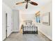 Well-lit bedroom featuring neutral décor, soft carpeting, and a modern ceiling fan for added comfort at 435 S Tryon St # 301, Charlotte, NC 28202