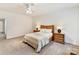 Bright bedroom features neutral decor, plush carpeting, and a stylish ceiling fan, creating a serene atmosphere at 435 S Tryon St # 301, Charlotte, NC 28202