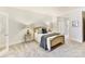 Comfortable bedroom with plush carpet, decorative bed, and matching side tables at 435 S Tryon St # 301, Charlotte, NC 28202