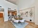 Open-concept dining room with a view of the kitchen, featuring a round table, modern chandelier, and hardwood floors at 435 S Tryon St # 301, Charlotte, NC 28202