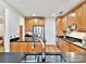 Spacious kitchen with wood cabinets, stainless steel appliances, and island sink at 435 S Tryon St # 301, Charlotte, NC 28202