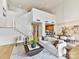 Open living room with staircase, dining area, and stylish contemporary furniture at 435 S Tryon St # 301, Charlotte, NC 28202