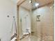 Modern shower with tan tiling, glass door, and recessed shelving at 435 S Tryon St # 301, Charlotte, NC 28202