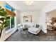 Bright sitting room with large window, comfortable seating, and an animal print carpet at 435 S Tryon St # 301, Charlotte, NC 28202
