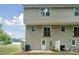 The home has a backyard with some room for outdoor seating, next to the home's tan siding at 5008 Winding Jordan Ln, Charlotte, NC 28269
