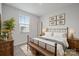 Cozy bedroom with neutral walls, a decorative bedframe, and a window with natural light at 5008 Winding Jordan Ln, Charlotte, NC 28269