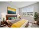 Stylish bedroom featuring a wooden bed frame, bright bedding, and natural lighting at 5008 Winding Jordan Ln, Charlotte, NC 28269