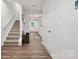 Inviting entryway featuring wood-look flooring, staircase, and neutral decor, offering a warm welcome to the home at 5008 Winding Jordan Ln, Charlotte, NC 28269