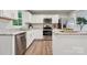 Modern kitchen features stainless steel appliances, white cabinets, and granite countertops, offering a stylish space at 5008 Winding Jordan Ln, Charlotte, NC 28269