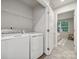 Practical laundry room with modern washer and dryer and wire shelving for convenient storage at 5008 Winding Jordan Ln, Charlotte, NC 28269