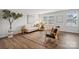 Living room featuring modern furniture, wood-look flooring, and neutral color palette at 5008 Winding Jordan Ln, Charlotte, NC 28269