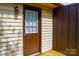 Back door featuring a window with horizontal gridlines, an outdoor light, and painted siding at 525 12Th Sw St # 26, Hickory, NC 28602