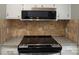 The kitchen features a stainless steel microwave, granite countertops, and tiled backsplash at 525 12Th Sw St # 26, Hickory, NC 28602