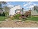 Cozy backyard with a wooden deck, a fire pit, and attractive landscaping at 630 S Myrtle School Rd, Gastonia, NC 28052