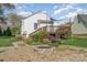 Cozy backyard with a wooden deck, a fire pit, and attractive landscaping at 630 S Myrtle School Rd, Gastonia, NC 28052