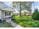 Well-maintained front yard showing an old mature tree and inviting front porch of this single-Gathering home at 630 S Myrtle School Rd, Gastonia, NC 28052