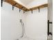 Functional laundry room with modern shelving and washer/dryer hookups at 630 S Myrtle School Rd, Gastonia, NC 28052