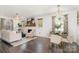 Spacious living room with fireplace, modern lighting, hardwood floors, and views to the dining area at 630 S Myrtle School Rd, Gastonia, NC 28052