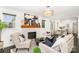 Bright living room featuring a decorative fireplace, modern chandelier, and chic neutral furniture arrangement at 630 S Myrtle School Rd, Gastonia, NC 28052