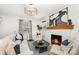 Chic living room featuring a cozy fireplace, modern lighting, and elegant decor accents at 630 S Myrtle School Rd, Gastonia, NC 28052