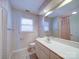 Traditional bathroom featuring a large mirror, patterned wallpaper, and a single-sink vanity at 907 Weymouth Dr, Gastonia, NC 28056