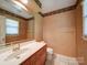 Cozy bathroom with wallpaper, vanity, and good natural light at 907 Weymouth Dr, Gastonia, NC 28056