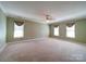 Large bedroom featuring neutral walls and carpet, with ample natural light at 907 Weymouth Dr, Gastonia, NC 28056
