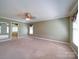 Expansive bedroom with a ceiling fan and large carpeted floor at 907 Weymouth Dr, Gastonia, NC 28056
