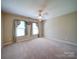 Empty bedroom with neutral walls and carpet, with ample natural light at 907 Weymouth Dr, Gastonia, NC 28056