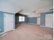 Large bedroom with a sloped ceiling, neutral carpet, and ample space for furniture at 907 Weymouth Dr, Gastonia, NC 28056