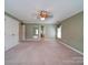Spacious bedroom featuring neutral walls and carpet, with multiple doors at 907 Weymouth Dr, Gastonia, NC 28056